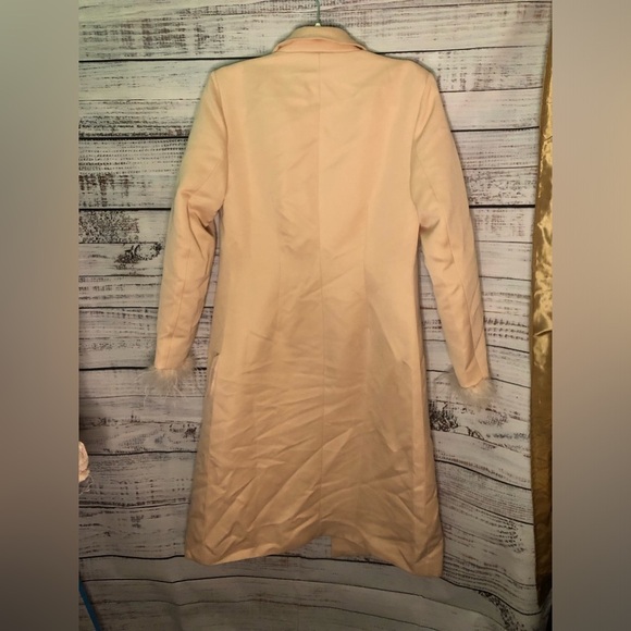 Feather Cuff Tuxedo Coat
Elegant Pink Peach Feather-Trimmed Coat - Picture 11 of 15